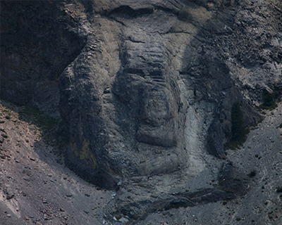 crater lake rocks look like faces